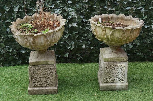 A PAIR OF RECONSTITUTED STONE LEAF MOULDED JARDINIERES (2)