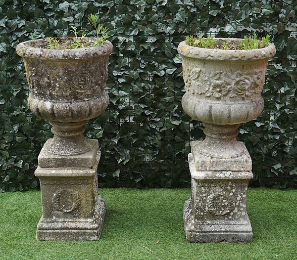 A PAIR OF RECONSTITUTED STONE FLORAL DECORATED JARDINIERES ON SQUARE BASES (2)