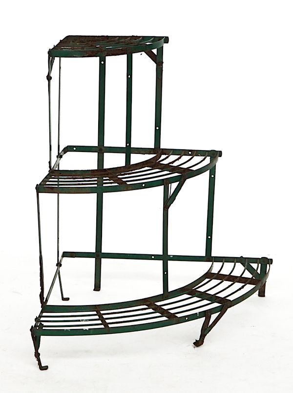 AN EARLY 20TH CENTURY GREEN PAINTED WROUGHT IRON CORNER THREE TIER PLANT STAND