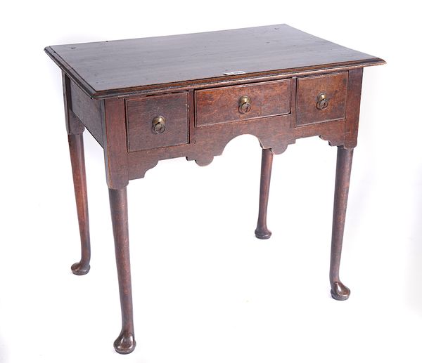 A MID-18TH CENTURY PROVINCIAL OAK THREE DRAWER LOWBOY