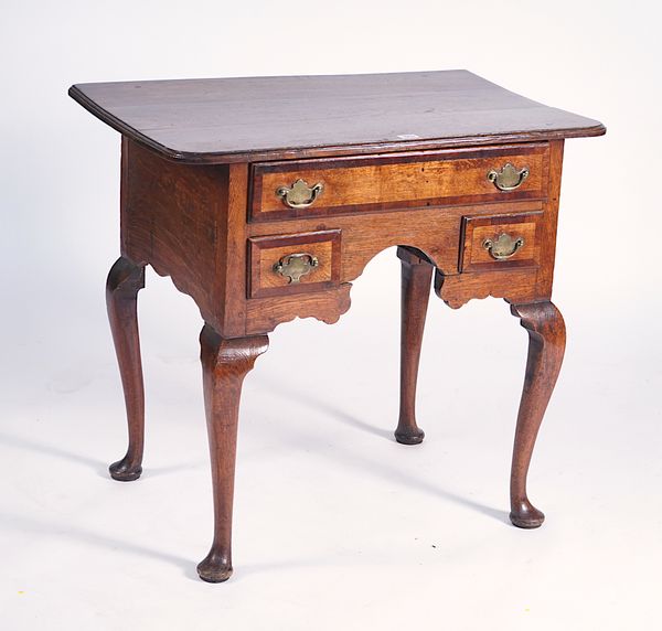 AN 18TH CENTURY MAHOGANY BANDED OAK THREE DRAWER LOWBOY