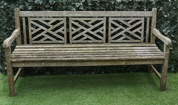 A HARDWOOD GARDEN BENCH, WITH TRIPLE LATTICE BACK