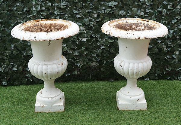 A PAIR OF WHITE PAINTED CAST IRON BALUSTER JARDINIERES (2)