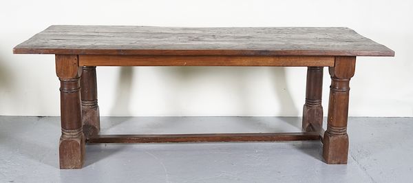 A 17TH CENTURY STYLE OAK PLANK TOP REFECTORY TABLE, ON GUN BARREL TURNED SUPPORTS