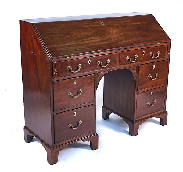 A GEORGE III MAHOGANY KNEEHOLE BUREAU WRITING DESK