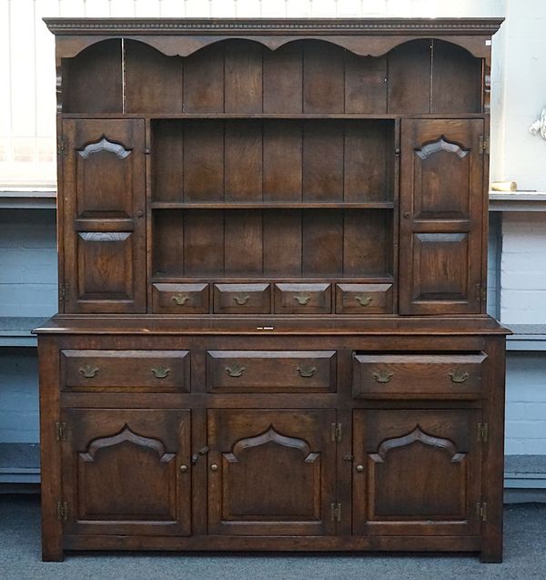 AN 18TH CENTURY STYLE ENCLOSED BACK OAK DRESSER