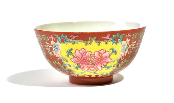 A CHINESE CORAL-GROUND FAMILLE-ROSE `PEONY' BOWL