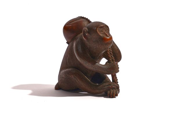 A JAPANESE WOOD NETSUKE OF A MONKEY