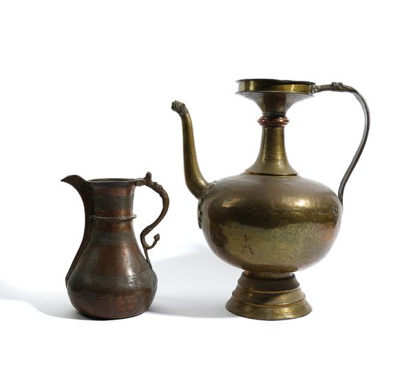 A LARGE INDIAN BRASS EWER AND AN ENGRAVED COPPER JUG (2)