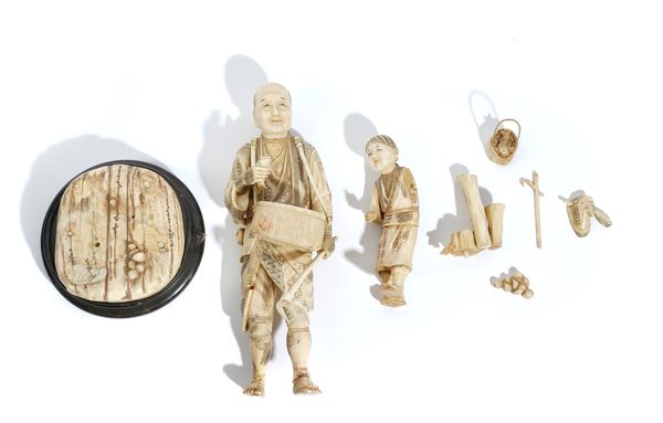 A LARGE JAPANESE SECTIONAL IVORY OKIMONO OF A FISHERMAN AND CHILD