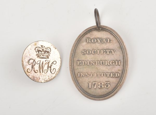 A SILVER OVAL MEDALLION AND A GEORGE III SILVER HUNT BUTTON (2)