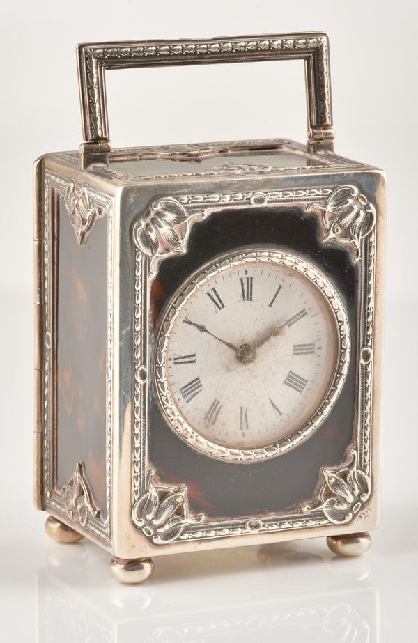 AN EDWARDIAN SILVER MOUNTED TORTOISESHELL CARRIAGE CLOCK