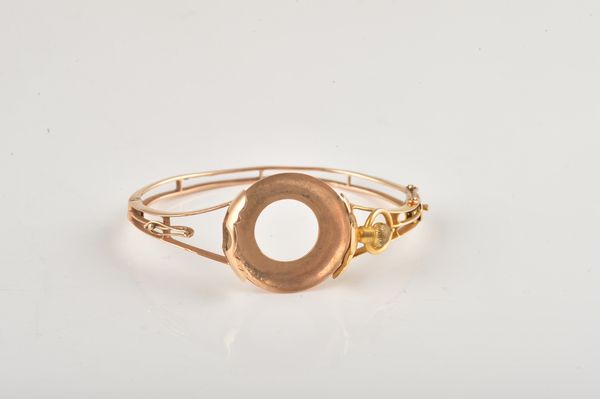 A GOLD OVAL HINGED BANGLE TO HOLD A FOB WATCH