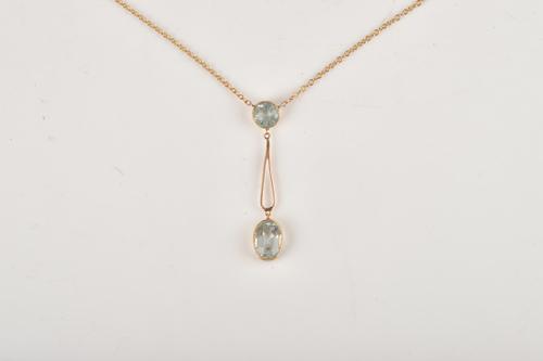 A GOLD AND AQUAMARINE TWO STONE PENDANT NECKLACE