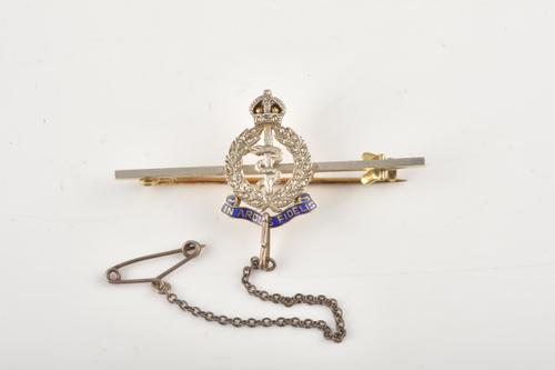A DIAMOND SET AND ENAMELLED GOLD AND PLATINUM R A M C BROOCH