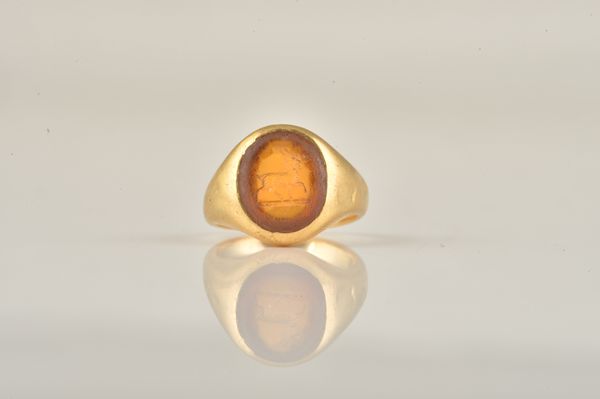 A GOLD AND CITRINE SIGNET RING