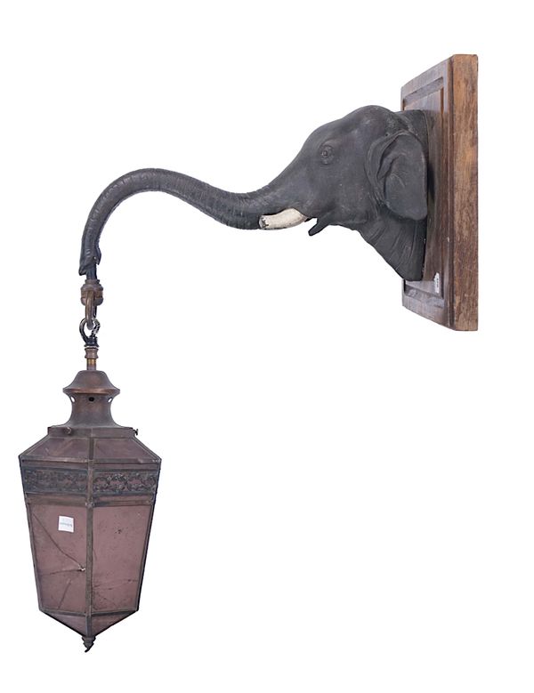 A PATINATED BRONZE ELEPHANT HEAD HANGING WALL LIGHT