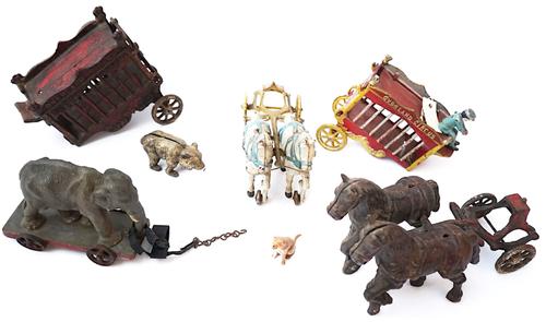 A GROUP OF AMERICAN PAINTED CAST-IRON 'OVERLAND CIRCUS'  HORSE DRAWN CARRIAGES AND ANIMALS  (8)