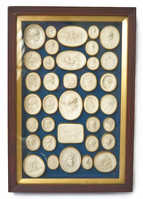 A FRAMED GROUP OF THIRTY-SIX ITALIAN PLASTER INTAGLIO IMPRESSIONS