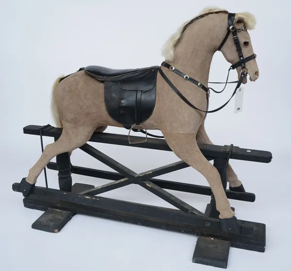 A 20TH CENTURY SUEDE UPHOLSTERED ROCKING HORSE, ON EBONISED BASE