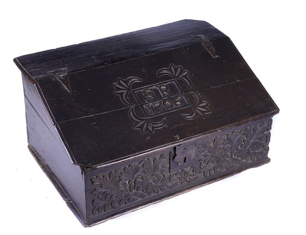 AN EARLY 18TH CENTURY CARVED OAK SLOPE FRONT BIBLE BOX