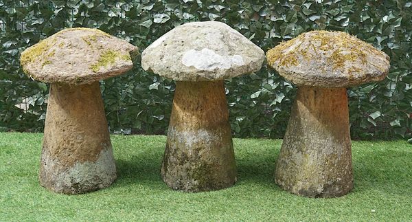 THREE CARVED STONE STADDLE STONES (3)