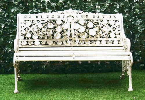 AFTER COALBROOKDALE; A WHITE PAINTED ALUMINIUM GRADEN BENCH, IN THE NASTURTIUM PATTERN