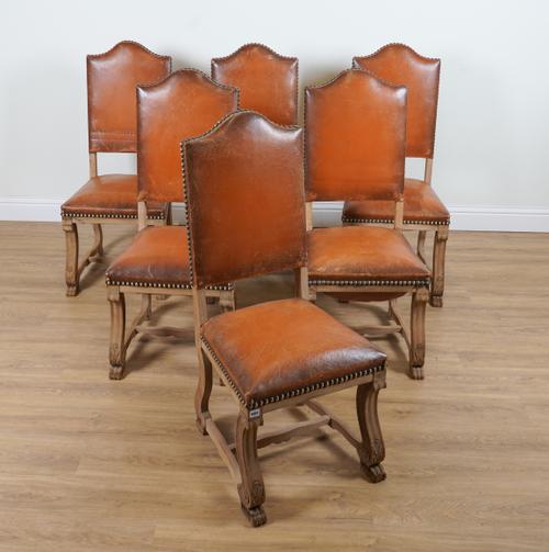 A SET OF SIX FRENCH OAK FRAMED HUMP BACK DINING CHAIRS