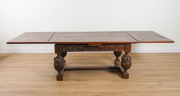 A 17TH CENTURY STYLE OAK DRAW LEAF EXTENDING DINING TABLE