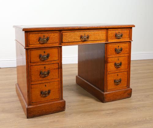 A LATE 19TH CENTURY OAK NINE DRAWER PEDESTAL DESK