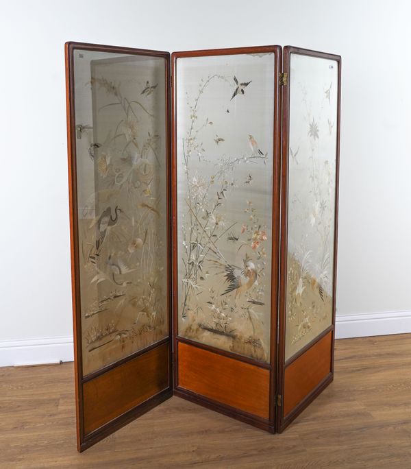 AN EARLY 20TH CENTURY CHINESE HARDWOOD FRAMED THREE FOLD DRAUGHT SCREEN