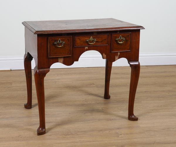 A MID 18TH CENTURY FEATHER BANDED WALNUT THREE DRAWER LOWBOY