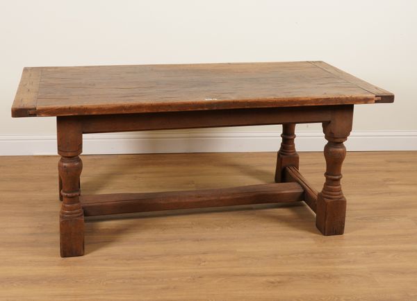 A 17TH CENTURY STYLE OAK PLANK TOP REFECTORY TABLE ON TURNED SUPPORTS