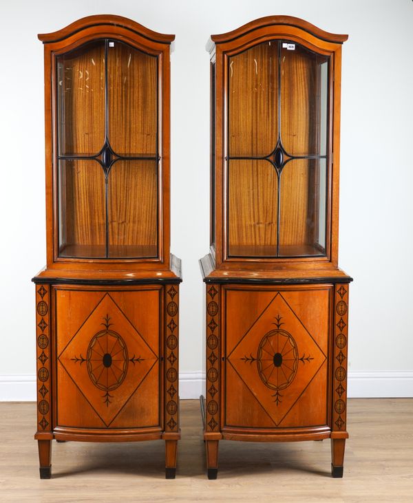 A PAIR OF 19TH CENTURY BIEDERMEIER FRUITWOOD BONNET TOPPED, SERPENTINE FRONTED DISPLAY CABINET CUPBOARDS