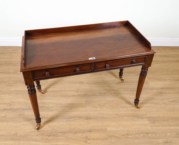 A VICTORIAN MAHOGANY TWO DRAWER WRITING TABLE