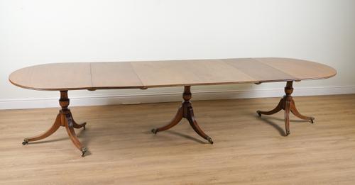 A REGENCY STYLE MAHOGANY TRIPLE PILLAR D-END EXTENDING DINING TABLE
