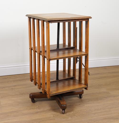 AN EDWARDIAN OAK SQUARE REVOLVING BOOKCASE