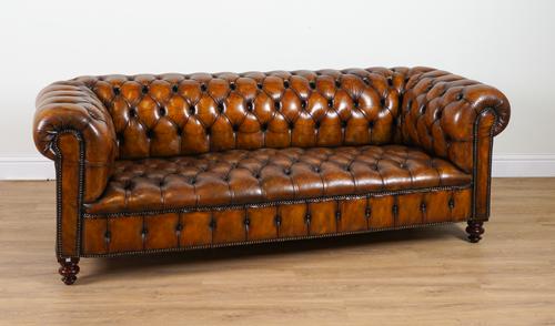 A BRASS STUDDED TAN LEATHER UPHOLSTERED BUTTON BACK CHESTERFIELD SOFA