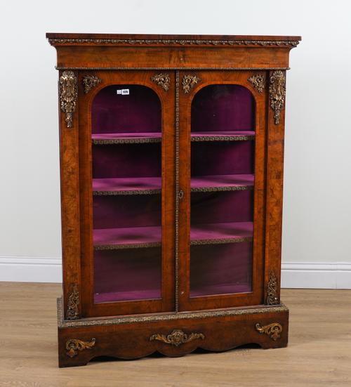 A VICTORIAN GILT METAL MOUNTED FIGURED WALNUT GLAZED TWO DOOR DISPLAY CABINET