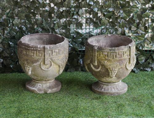 A PAIR OF RECONSTITUTED STONE JARDINIERES WITH GREEK KEY AND GRAPE RELIEF MOULDED BODIES (2)