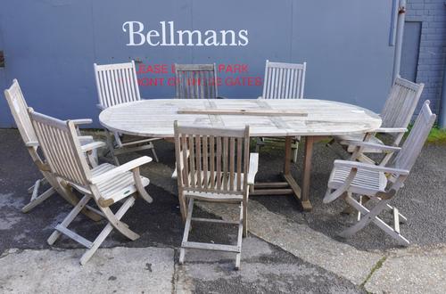 WESTMINSTER TEAK; A HARDWOOD OVAL EXTENDING DINING TABLE (9)