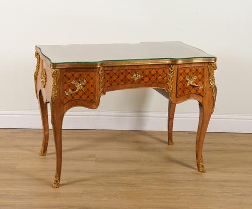 A LOUIS XV STYLE ORMOLU MOUNTED MARQUETRY INLAID MAHOGANY AND SATINWOOD THREE DRAWER BUREAU PLAT