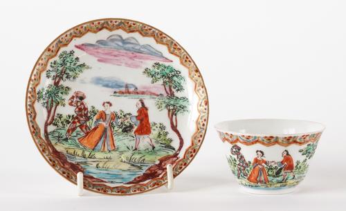 A JAPANESE PORCELAIN DUTCH-DECORATED TEABOWL AND SAUCER