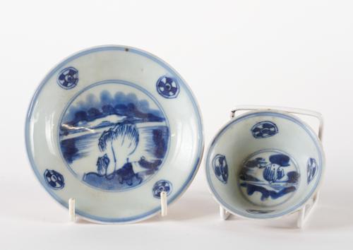 A CHINESE BATAVIAN WARE EUROPEAN-DECORATED TEABOWL AND SAUCER (2)