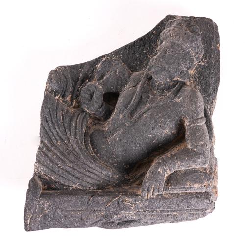 A GANDHARA GREY SCHIST RELIEF FRAGMENT DEPICTING A RECLINING MALE DEITY