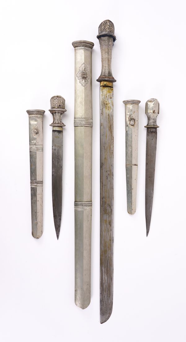 PROBABLY TIBETAN: A WHITE METAL ALLOY SWORD AND TWO DAGGERS (3)