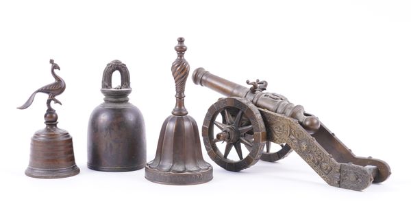 A BRONZE TABLE CANNON TOGETHER WITH THREE BRONZE TABLE BELLS (4)