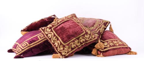 SIX PURPLE VELVET AND GILT THREAD TASSELLED CUSHIONS (6)