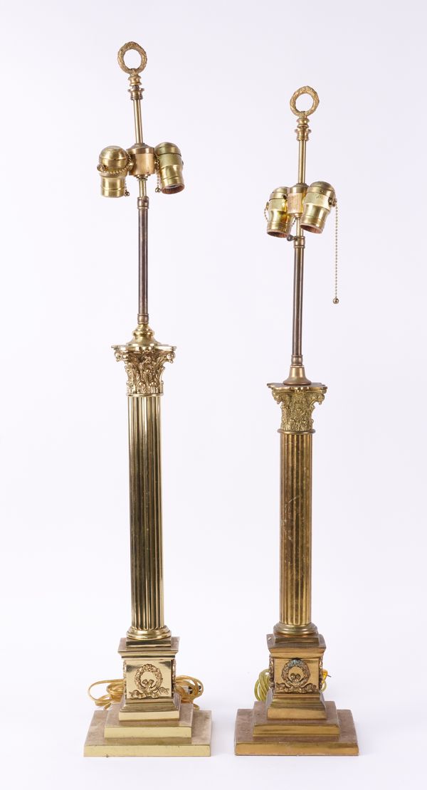 A GRADUATED PAIR OF GILT-METAL CORINTHIAN COLUMN TABLE LAMPS (2)