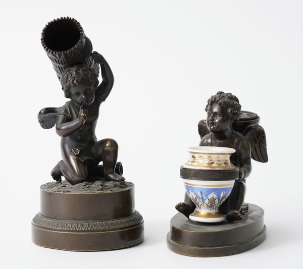 A BRONZE WINGED CHERUB DESK STAND AND A CHERUB VESTA STRIKER (2)